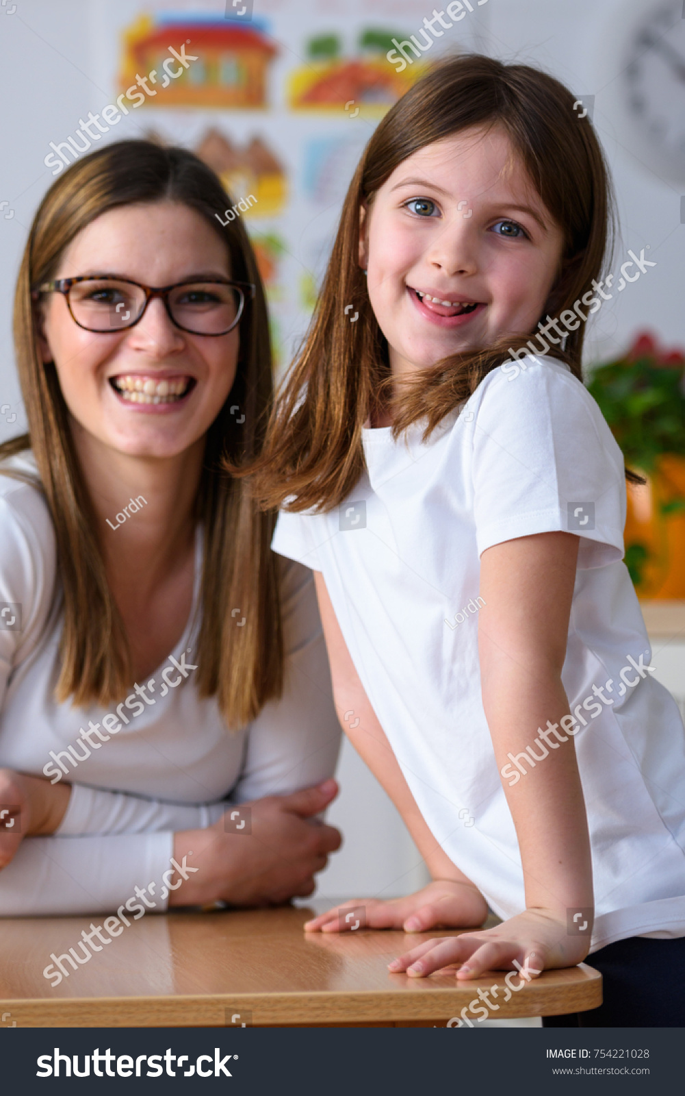 stock-photo-portrait-of-kindergarten-teacher-with-cute-girl-754221028
